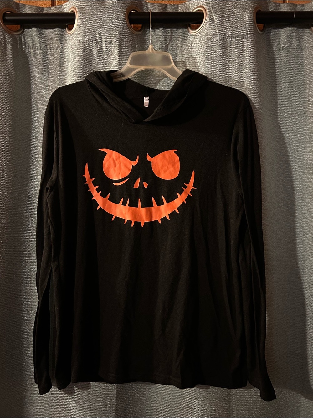 Black unisex Hooded Long-Sleeve Shirt with Orange Jack-O'-Lantern Face